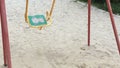 Lonely swing like symbol loneliness and boring. Solitariness empty playground swing on sand.