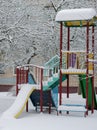 A lonely swing set, Playground, winter under the snow, in the city yard