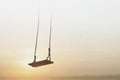 Lonely swing surreally hanging from the sky Royalty Free Stock Photo