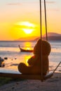 Lonely Teddy Bear sitting on a swing in front Rawai beach Royalty Free Stock Photo