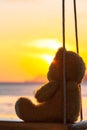 lonely Teddy Bear sitting on a swing in front Rawai beach Royalty Free Stock Photo