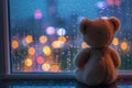 Lonely teddy crying at window with colorful love shape bokeh