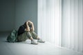 Lonely teenage girl looks sad near the window Royalty Free Stock Photo