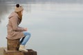 Lonely teenage girl sitting on the dock Royalty Free Stock Photo