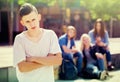Lonely teenager standing away Royalty Free Stock Photo
