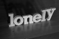 Lonely, text words typography written with wooden letter on black background, life and business negativity