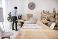 lonely tired businessman standing at conference hall with paperwork