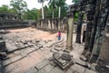 Lonely torist of Angkor reading guidebook at 12th century Bayon temple, Cambodia. Historical landmark