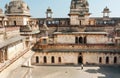 Lonely tourist standing inside courtyard of ancient structure of Jahangir Mahal in India