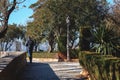 Lonely tourist is walking away from small park of Ronda town, Spain