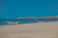 Lonely traditional Colombian fishing boats on sea water with clear water and blue sky - at Cabo de la vela, La guajira, Colombia