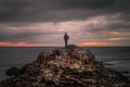 Lonely traveler on the top of the Giant`s Causeway at sunset, Northern Ireland
