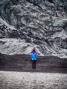 Lonely turist girl near a glacier