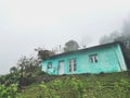 Lonely Turquoise House in White Mountain Fog. Royalty Free Stock Photo
