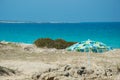 Lonely umbrella on rocky beach