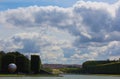 A lonely view of Versailles park, France. The geometric combination of green trees, grass areas and Grand Canal Royalty Free Stock Photo