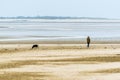 A lonely walk on the beach at Llansteffan, Wales beside the river Towy estuary