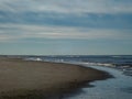 A lonely walker on the beaches of the Ameland island in the Netherlands in Autumn Royalty Free Stock Photo