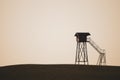 Lonely watch tower. observation post standing alone on the hill. hunting lodge in the field. solitude concept Royalty Free Stock Photo