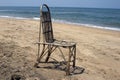 The lonely wattled chair costs on a beach, against the sea. GOA India beach Royalty Free Stock Photo