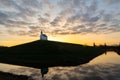 Silhouette of a church on a hill, reflected in water, at sunrise, the Hague, Netherlands Royalty Free Stock Photo