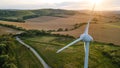 Lonely wind turbine in farm fields Royalty Free Stock Photo