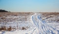 Lonely winter road in a field, in the form of zigzag