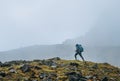 Lonely woman with backpack and trekking poles going by mountain route during Makalu Barun National Park near Tuli Kharka