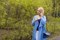 The lonely woman in a beautiful knitted jacket. The beautiful woman on walk. Fashionable clothes. Royalty Free Stock Photo