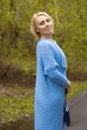 The lonely woman in a beautiful knitted jacket. The beautiful woman on walk. Fashionable clothes. Royalty Free Stock Photo