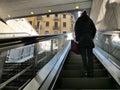 Lonely woman on escalator back view