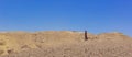 Lonely woman fluttering dress portrait in dry ground global warming hot desert landscape nature environment vivid blue sky