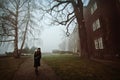 Lonely woman in the foggy park Royalty Free Stock Photo