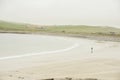 A lonely woman on an isolated beach in Scotland