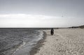 Lonely woman with a kite on the beach of the North Sea, Cuxhaven, Germany Royalty Free Stock Photo