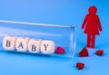 Lonely woman and laboratory test tube with lettering baby. Artificial insemination concept.