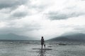 Lonely woman looks at infinity and uncontaminated nature on a stormy day Royalty Free Stock Photo