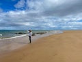 Lonely woman Moray Coastal Trail, Scotland