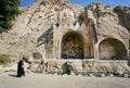 Lonely woman in muslim dress hijab standing near the monument Taq-e Bostan Royalty Free Stock Photo