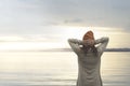 Lonely woman relaxes in front of a spectacular landscape of nature