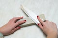 Lonely woman sharpening a knife on a grindstone in the kitchen