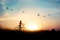 Lonely woman standing with bicycle on road of paddy field