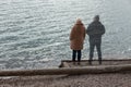 Lonely woman standing by the lake with ghost of a man standing by her side Royalty Free Stock Photo