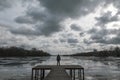 Lonely woman standinng on the wooden pier Royalty Free Stock Photo