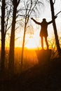 Lonely woman at sunrise. Solitude concept, alone in forest Royalty Free Stock Photo