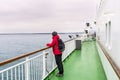 Lonely woman tourist on the deck of a ferry in navigation Royalty Free Stock Photo