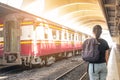 Lonely woman on train platform of railway station her feel homesick. Royalty Free Stock Photo