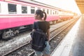 Lonely woman on train platform of railway station her feel homesick. Royalty Free Stock Photo