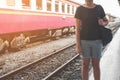 Lonely woman on train platform of railway station her feel homesick. Royalty Free Stock Photo