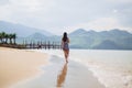 Lonely woman walk on sandy beach